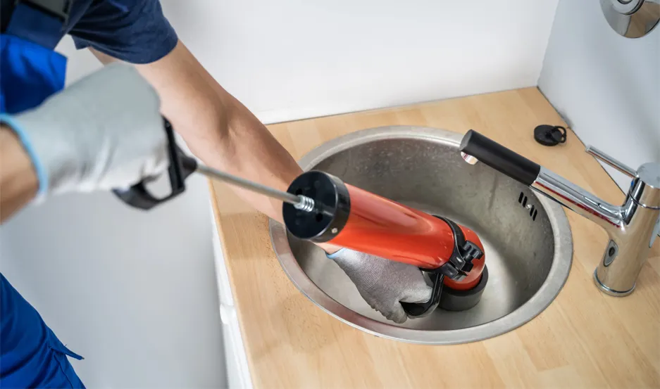 Plumber performing camera-guided drain cleaning in a Franklin County PA home